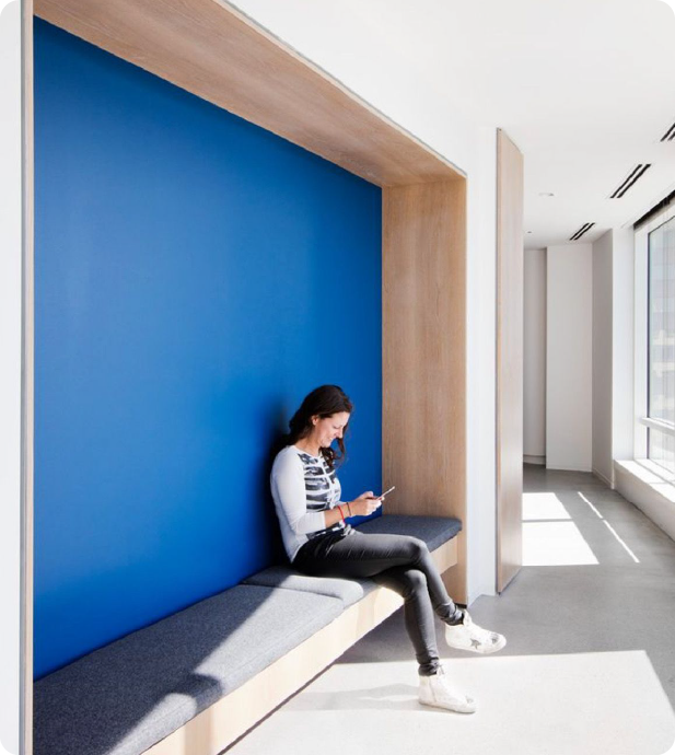 Person sitting with laptop in a modern bright office